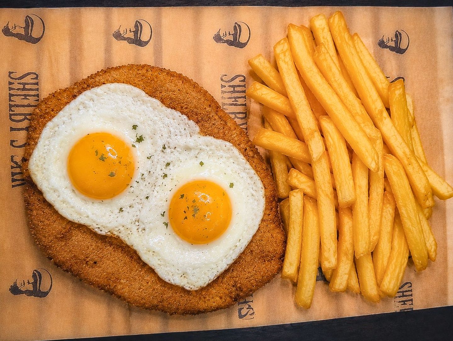 Milanesa a caballo con papas fritas.